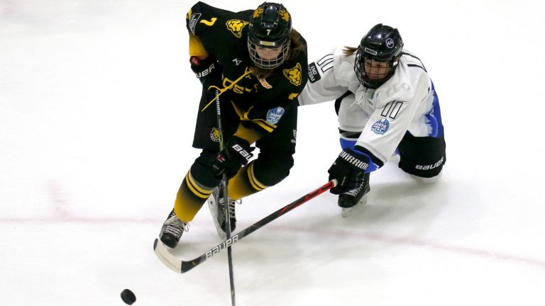 Boston Pride forward Mary Parker (7) and Minnesota Whitecaps forward Lisa Martinson (11) make a play for the puck during the second period of the Isobel Cup championship hockey game Saturday, March 27, 2021, in Boston. (Mary Schwalm/AP Photo)