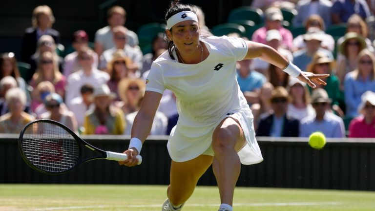 Tunisia's Ons Jabeur returns to Germany's Tatjana Maria in a women's singles semifinal match on day eleven of the Wimbledon tennis championships in London, Thursday, July 7, 2022. (Kirsty Wigglesworth/AP)