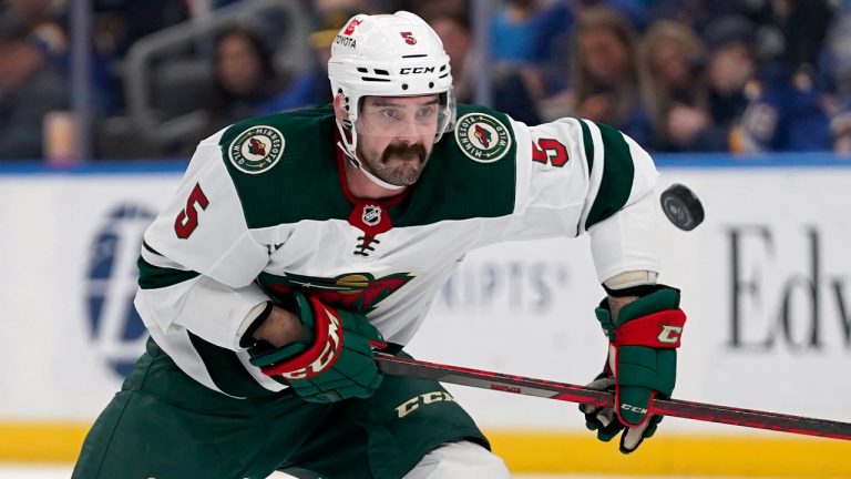 Minnesota Wild's Jacob Middleton chases after a loose puck during the first period of an NHL hockey game against the St. Louis Blues Saturday, April 16, 2022, in St. Louis. (Jeff Roberson/AP)