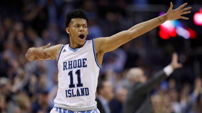 Jeff Dowtin, pictured while playing for Rhode Island in 2018, celebrates his 3-point shot during the second half of an NCAA college basketball game against Saint Joseph's in the semifinals of the Atlantic 10 Conference tournament. (Alex Brandon/AP) 