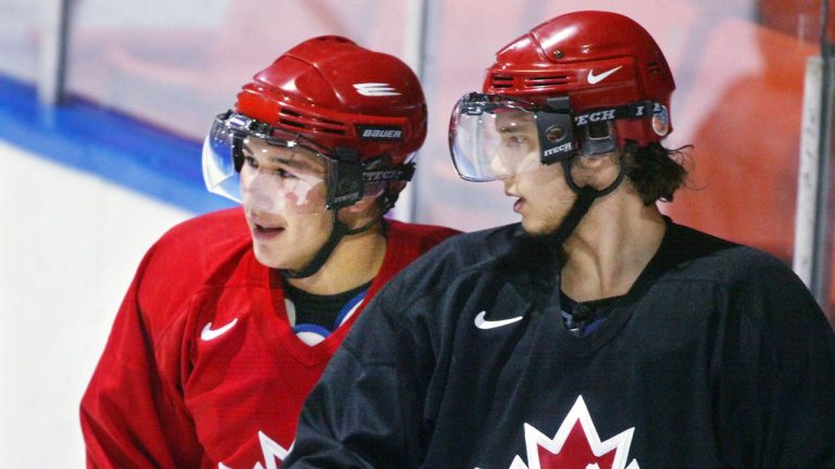 Canada's Jordin Tootoo, left, and Steve Eminger watch the action during a team practice in Dartmouth, N.S. at the World Junior Hockey championship. (Andrew Vaughan/CP)