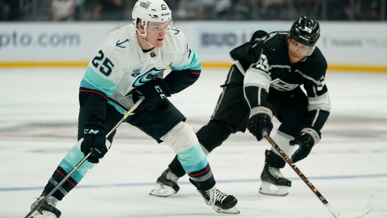 Seattle Kraken center Karson Kuhlman (25) controls the puck against Los Angeles Kings center Quinton Byfield (55) during the third period of an NHL hockey game Saturday, March 26, 2022, in Los Angeles. (Ashley Landis/AP)