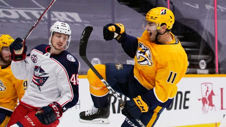 Luke Kunin (11), then with the Nashville Predators, celebrates after scoring a goal against the Columbus Blue Jackets in the second period of an NHL hockey game Thursday, Jan. 14, 2021, in Nashville, Tenn. (Mark Humphrey/AP)