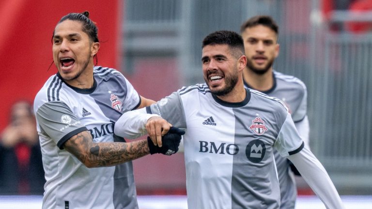 Toronto FC midfielder Alejandro Pozuelo (10) is congratulated by teammate Carlos Salcedo (3) after scoring on D.C. United during first half MLS in Toronto on Saturday March 19, 2022. (Frank Gunn/CP)