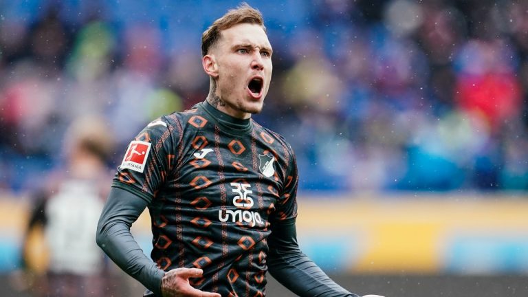 Hoffenheim's David Raum celebrates after scoring his side first goal during a German Bundesliga soccer match between TSG 1899 Hoffenheim and VfL Bochum in Sinsheim, Germany, Saturday, April 2, 2022. (Uwe Anspach/dpa via AP)