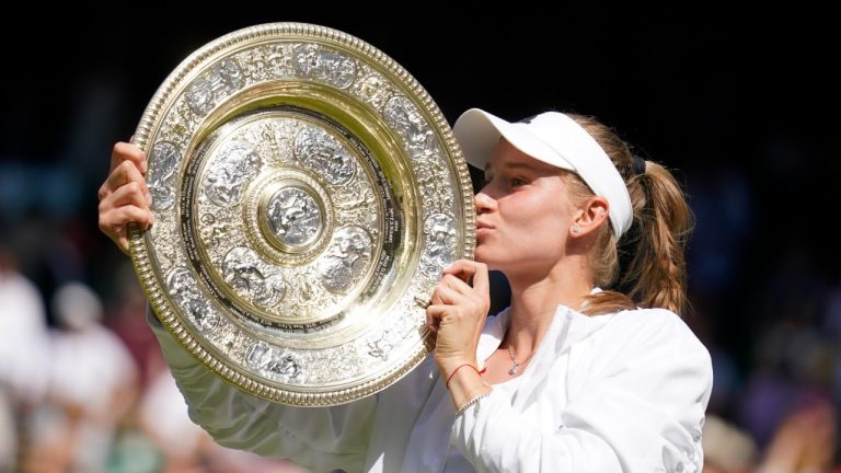 Kazakhstan's Elena Rybakina kisses the trophy as she celebrates after beating Tunisia's Ons Jabeur to win the final of the women's singles on day thirteen of the Wimbledon tennis championships in London, Saturday, July 9, 2022. (Gerald Herbert/AP)