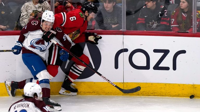 Colorado Avalanche center Dylan Sikura (9) and Chicago Blackhawks defenseman Jake McCabe (6) chase the puck during the second period of an NHL hockey game in Chicago, Friday, Jan. 28, 2022. (Nam Y. Huh/AP)