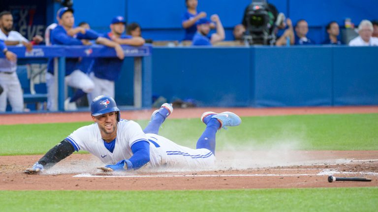 Toronto Blue Jays' George Springer (4) slides into home plate during third inning AL MLB baseball action against the Detroit Tigers. (Christopher Katsarov/CP)