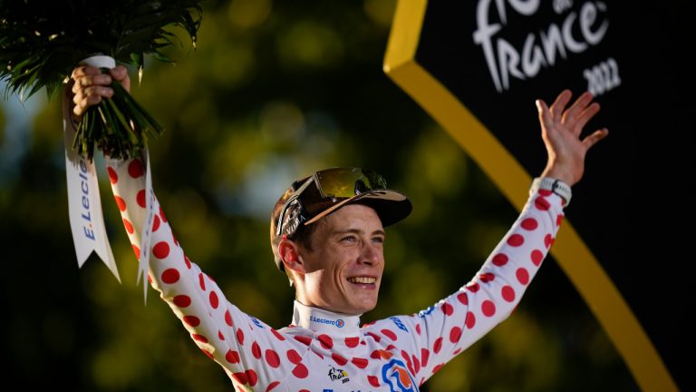 Tour de France winner Denmark's Jonas Vingegaard, who also won the best climber's dotted jersey, celebrates on the podium after the twenty-first stage of the Tour de France cycling race over 116 kilometres (72 miles) with start in Paris la Defense Arena and finish on the Champs Elysees in Paris, France, Sunday, July 24, 2022. (Daniel Cole/AP)