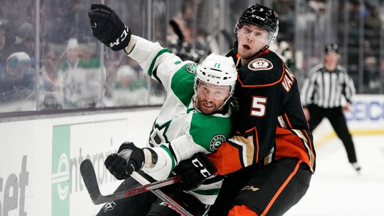 Dallas Stars' Luke Glendening, left, is defended by Anaheim Ducks' Urho Vaakanainen during the first period of an NHL hockey game Tuesday, March 29, 2022, in Anaheim, Calif. (Jae C. Hong/AP)