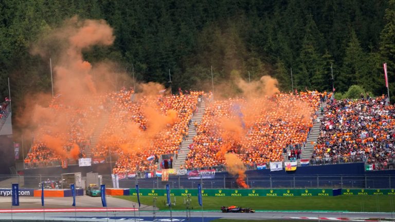 Fans cheer on Red Bull driver Max Verstappen, of the Netherlands, during the Austrian F1 Grand Prix at the Red Bull Ring racetrack in Spielberg, Austria, Sunday, July 10, 2022. (Matthias Schrader/AP)