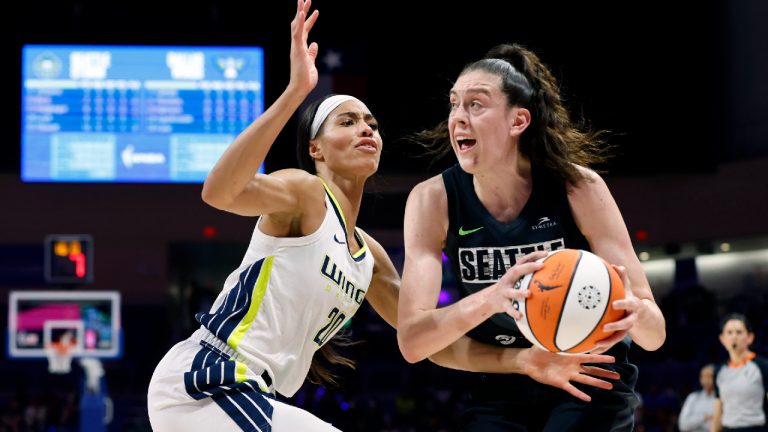 Seattle Storm forward Breanna Stewart, right, looks to the basket as she is covered by Dallas Wings forward Isabelle Harrison (20) during the first half of a WNBA basketball game in Arlington, Texas, Friday, June 10, 2022. (Tom Fox/The Dallas Morning News via AP)