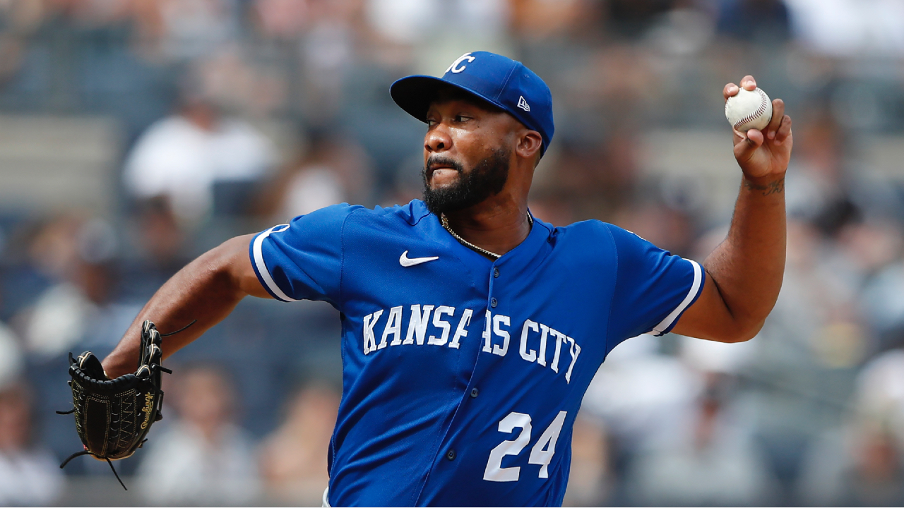 Kansas City Royals fans hold up pictures of starting pitcher