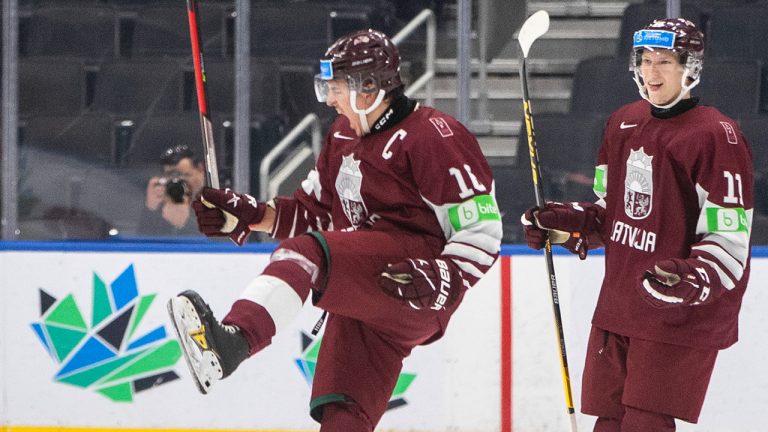 Latvia's Ralfs Bergmanis (16) and Dans Locmelis (11) celebrate a goal against Czechia during second period IIHF World Junior Hockey Championship action in Edmonton on Sunday August 14, 2022. (Jason Franson/CP)