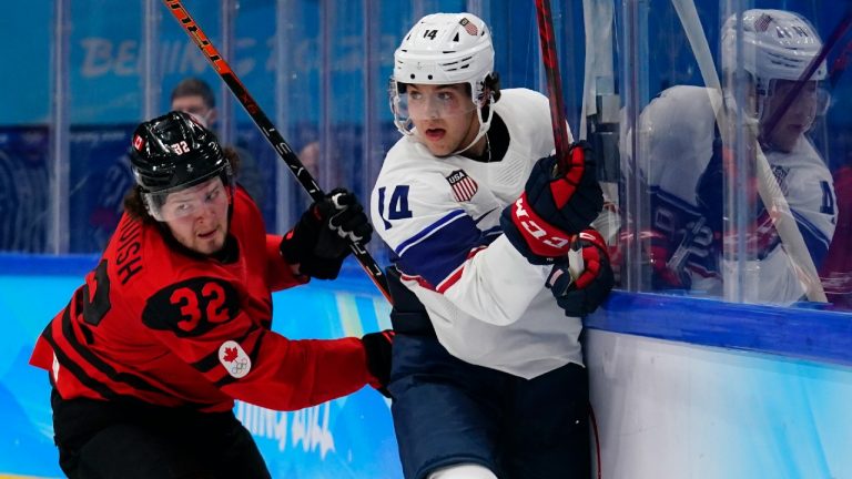 Canada's Mason McTavish (32) and United States' Brock Faber (14) skate behind the net during a preliminary round men's hockey game at the 2022 Winter Olympics, Saturday, Feb. 12, 2022, in Beijing. (Matt Slocum/AP)