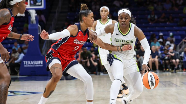 Dallas Wings guard Arike Ogunbowale, right, is defended by Washington Mystics guard Natasha Cloud (9) during a WNBA basketball game Thursday, July 28, 2022, in Arlington, Texas. (Rebecca Slezak/The Dallas Morning News via AP)