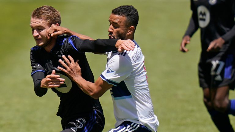 CF Montréal midfielder Djordje Mihailovic, left, and Vancouver Whitecaps midfielder Caio Alexandre, right, battle for the ball in the first half during an MLS soccer game Saturday, May 8, 2021, in Sandy, Utah. (Rick Bowmer/AP)