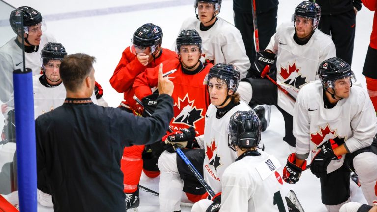 Canada’s National Junior Team assistant coach Michael Dyck, left, gives instructions during a training camp practice in Calgary, Tuesday, Aug. 2, 2022. (Jeff McIntosh/CP)