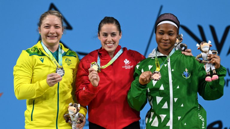 From left, Australia's Sarah Maureen Cochrane, Canada's Maude G Charron and Nigeria's Islamiyat Adebukola Yusuf pose on the podium with their medals after the Women's 64kg Final at the Commonwealth Games in Birmingham, England, Monday, Aug. 1, 2022. (Rui Vieira/AP)