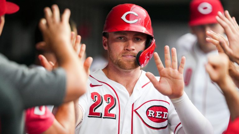 Cincinnati Reds' Brandon Drury (22) celebrates with teammates after scoring on a single by Kyle Farmer during the third inning of a baseball game against the Miami Marlins, Monday, July 25, 2022, in Cincinnati. (Jeff Dean/AP Photo)