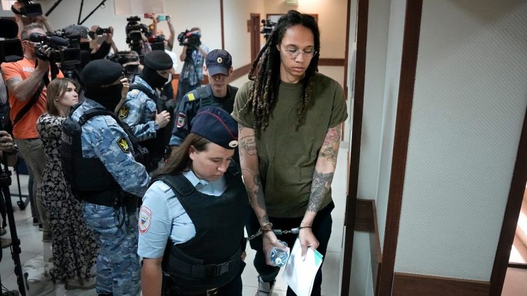 WNBA star and two-time Olympic gold medalist Brittney Griner is escorted in a court prior to a hearing, in Khimki, just outside Moscow, Russia, Tuesday, Aug. 2, 2022. Since Brittney Griner last appeared in her trial for cannabis possession, the question of her fate expanded from a tiny and cramped courtroom on Moscow's outskirts to the highest level of Russia-US diplomacy. (Alexander Zemlianichenko/AP Photo)