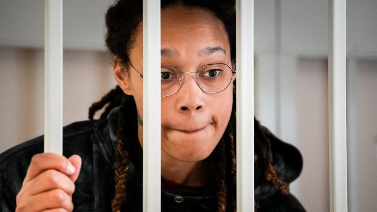 WNBA star and two-time Olympic gold medalist Brittney Griner speaks to her lawyers standing in a cage at a court room prior to a hearing, in Khimki just outside Moscow, Russia, Tuesday, July 26, 2022. American basketball star Brittney Griner returns Tuesday to a Russian courtroom for her drawn-out trial on drug charges that could bring her 10 years in prison of convicted. (Alexander Zemlianichenko/AP, Pool)