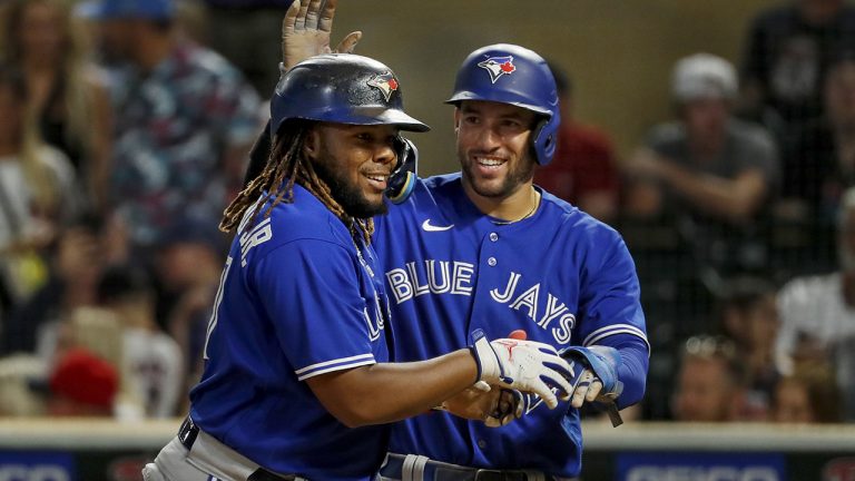 Toronto Blue Jays' Vladimir Guerrero, left, celebrates his three-run home run against the Minnesota Twins with George Springer during the eighth inning of a baseball game Thursday, Aug. 4, 2022, in Minneapolis. (AP Photo/Bruce Kluckhohn)