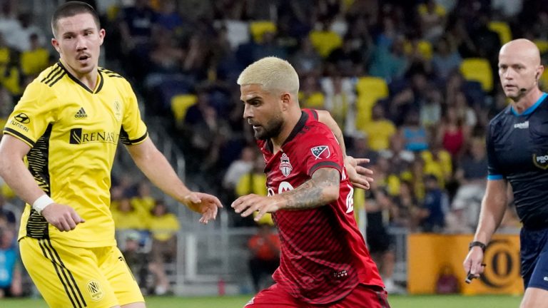 Toronto FC's Lorenzo Insigne (24) dribbles the ball past Nashville SC's Alex Muyl, left, as Insigne moves in to score a goal during the second half of an MLS soccer match Saturday, Aug. 6, 2022, in Nashville, Tenn. (Mark Humphrey/AP)