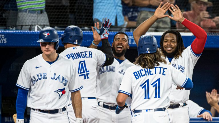 Toronto Blue Jays celebrate after Bo Bichette (11) and pitch hitter George Springer (4) score on a double by Santiago Espinal (5) during seventh inning AL MLB baseball action against the Baltimore Orioles, in Toronto on Wednesday, August 17, 2022. (Christopher Katsarov/CP)