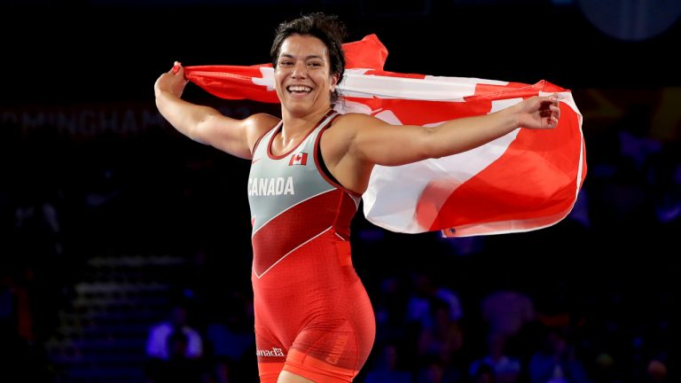 Canada's Justina di Stasio celebrates winning against Nigeria's Hannah Amuchechi Rueben in the Women's 76kg Gold Medal match wrestling at the Coventry Arena on day nine of the 2022 Commonwealth Games in Coventry, England, Saturday Aug. 6, 2022. (Bradley Collyer/AP)