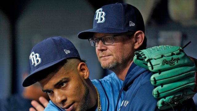 Tampa Bay Rays pitching coach Kyle Snyder, left, looks on as Shane  McClanahan holds his all-star jersey before a baseball game against the  Baltimore Orioles Saturday, July 16, 2022, in St. Petersburg