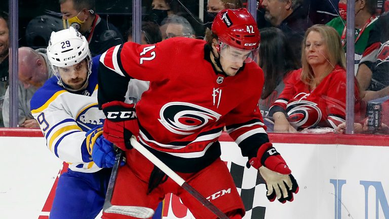 Carolina Hurricanes' Maxime Lajoie (42) controls the puck in front of Buffalo Sabres' Vinnie Hinostroza (29) during the third period of an NHL hockey game in Raleigh, N.C., Saturday, Dec. 4, 2021. (Karl B DeBlaker/AP)