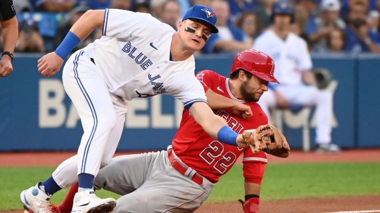 Los Angeles Angels' second baseman David Fletcher (22) slides safely into third base ahead of a tag by Toronto Blue Jays’ third baseman Matt Chapman in first inning American League baseball action in Toronto on Friday, August 26, 2022. (Jon Blacker/CP)