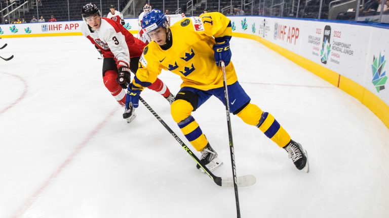 Sweden's Fabian Lysell (11) is chased by Austria's Lukas Horl (3) during second period IIHF World Junior Hockey Championship action in Edmonton on Friday August 12, 2022. (Jason Franson/CP)