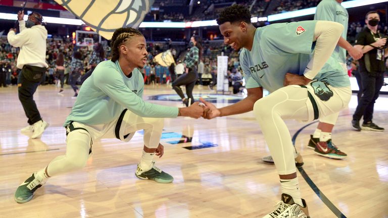 Memphis Grizzlies guard Ja Morant, left, and forward Jaren Jackson Jr. (13) greet each other before an NBA basketball game against the Oklahoma City Thunder, Monday, Dec. 20, 2021, in Memphis, Tenn. (Brandon Dill/AP)