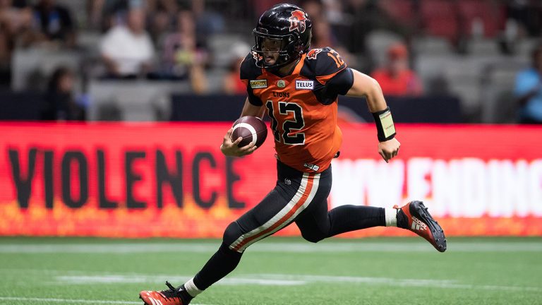 B.C. Lions quarterback Nathan Rourke runs for a touchdown during the second half of CFL football game against the Edmonton Elks in Vancouver, on Saturday, August 6, 2022. (Darryl Dyck/CP)