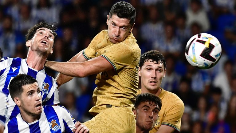 Barcelona's Robert Lewandowski, centre jumps for a header during a Spanish La Liga soccer match between Real Sociedad and Barcelona at the Reale Arena in San Sebastian, Spain, Sunday, Aug. 21, 2022. (Alvaro Barrientos/AP)