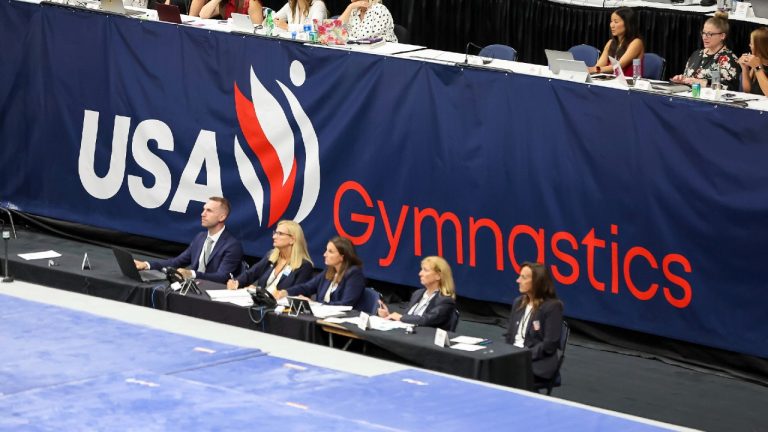 Signage showing the new USA Gymnastics logo is displayed during the 2022 U.S. Gymnastics Championships, Friday, Aug. 19, 2022, in Tampa, Fla.(Mike Carlson/AP)