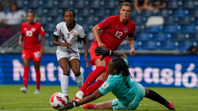 Canada's Christine Sinclair makes an attempt to score as Trinidad and Tobago's goalkeeper Kimira Forbes dives for the ball during a CONCACAF Women's Championship soccer match in Monterrey, Mexico, Tuesday, July 5, 2022. (Fernando Llano/AP)