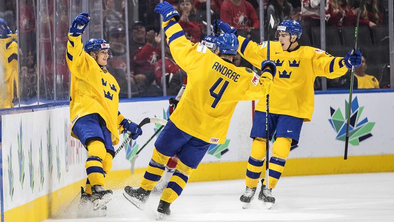 Sweden's Fabian Lysell (11), Emil Andrae (4) and  Daniel Ljungman (9) celebrate a goal against Czechia during first period IIHF World Junior Hockey Championship bronze medal game action in Edmonton on Saturday August 20, 2022. (Jason Franson/CP)