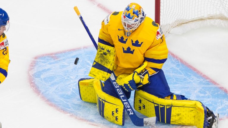 Sweden goalie Jesper Wallstedt (1) makes the save on Finland's Samuel Helenius (20) as Albin Sundsvik (29) defends during second period IIHF World Junior Hockey Championship action in Edmonton on Saturday, January 2, 2021. (Jason Franson/CP)