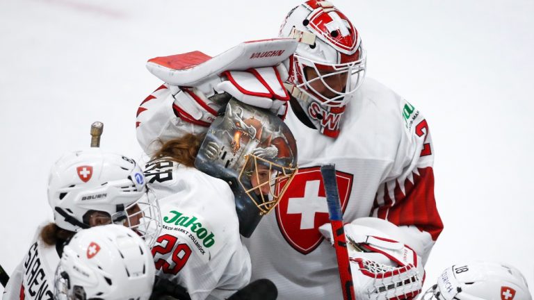 Switzerland's goalie Saskia Maurer, left, and Switzerland's goalie Andrea Braendli celebrate defeating Russian Olympic Committee during overtime quarterfinal IIHF Women's World Championship hockey action in Calgary, Alta., Saturday, Aug. 28, 2021. (Jeff McIntosh/CP)