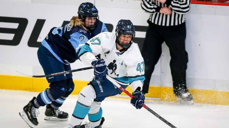 Team Bauer Jaime Bourbonnais, left, checks Team Sonnet Jamie Lee Rattray during second period PWHPA Dream Tour hockey action in Calgary, Alta., Monday, May 24, 2021. (Jeff McIntosh/CP)