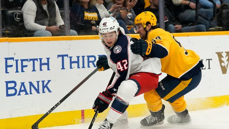 Columbus Blue Jackets center Alexandre Texier (42) and Nashville Predators defenseman Roman Josi (59) battle for the puck in the third period of an NHL hockey game Tuesday, Nov. 30, 2021, in Nashville, Tenn. (Mark Humphrey/AP Photo)