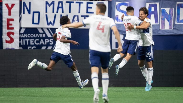 Vancouver Whitecaps' Simon Becher (29) and Ryan Raposo (27) celebrate Becher's tying goal against the Houston Dynamo during the second half of an MLS soccer game in Vancouver, on Friday, August 5, 2022. (Darryl Dyck/CP)