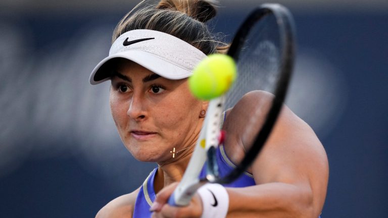 Bianca Andreescu, of Canada, returns the ball against Qinwen Zheng, of China, during the National Bank Open tennis tournament in Toronto on Thursday, August 11, 2022. (Nathan Denette/CP)