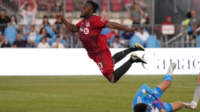 CF Montréal goalkeeper James Pantemis (41) makes a save as Toronto FC forward Ayo Akinola (20) jumps over him avoiding a collision during second half Voyageurs Cup semifinal soccer action against CF Montréal in Toronto on Wednesday, June 22, 2022. (Nathan Denette/CP)