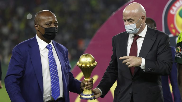 CAF President Patrice Motsepe, left, and FIFA President Gianni Infantino hold the African Cup of Nations 2022 trophy after the final soccer match between Senegal and Egypt at the Olembe stadium in Yaounde, Cameroon, Feb. 6, 2022. Motsepe is set to launch a 24-club super league that he has promised will revolutionize soccer on the continent and become its richest competition. The scheduled launch later Wednesday, Aug. 10, 2022, will come as Motsepe's organization reported a loss of nearly $50 million last year. (AP Photo/Sunday Alamba, File)