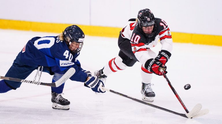 Noora Tulus of Finland in action with Sarah Fillier of Canada during the IIHF World Championship Women's ice hockey match between Finland and Canada in Herning, Denmark, Thursday, Aug. 25, 2022. (Bo Amstrup/Ritzau Scanpix via AP)