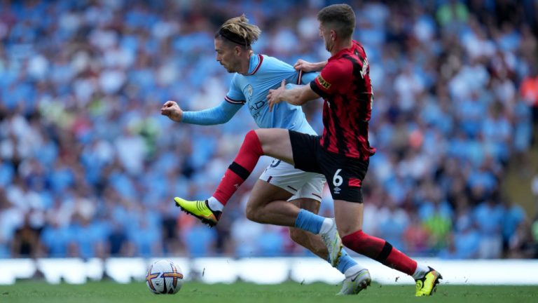 Manchester City's Jack Grealish, left, duels for the ball with Bournemouth's Chris Mepham during the English Premier League soccer match between Manchester City and Bournemouth at Etihad stadium in Manchester, England, Saturday, Aug. 13, 2022. (Jon Super/AP)